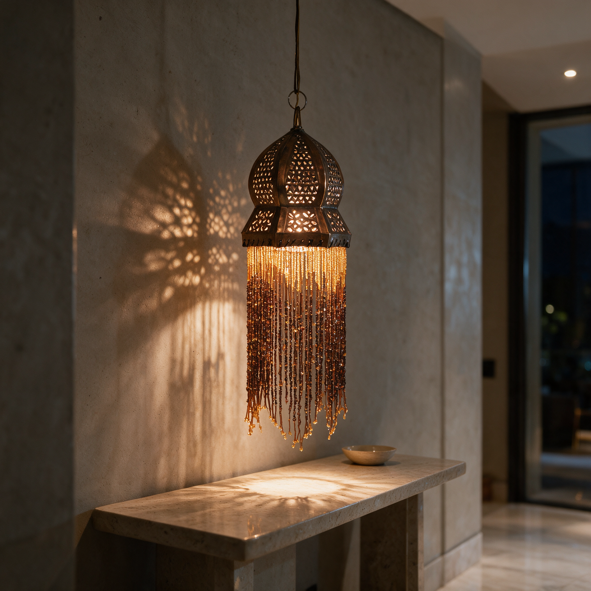 Dahlia Copper Fringe Lantern glowing above a console in the entrance hall of a modern Dubai villa at night