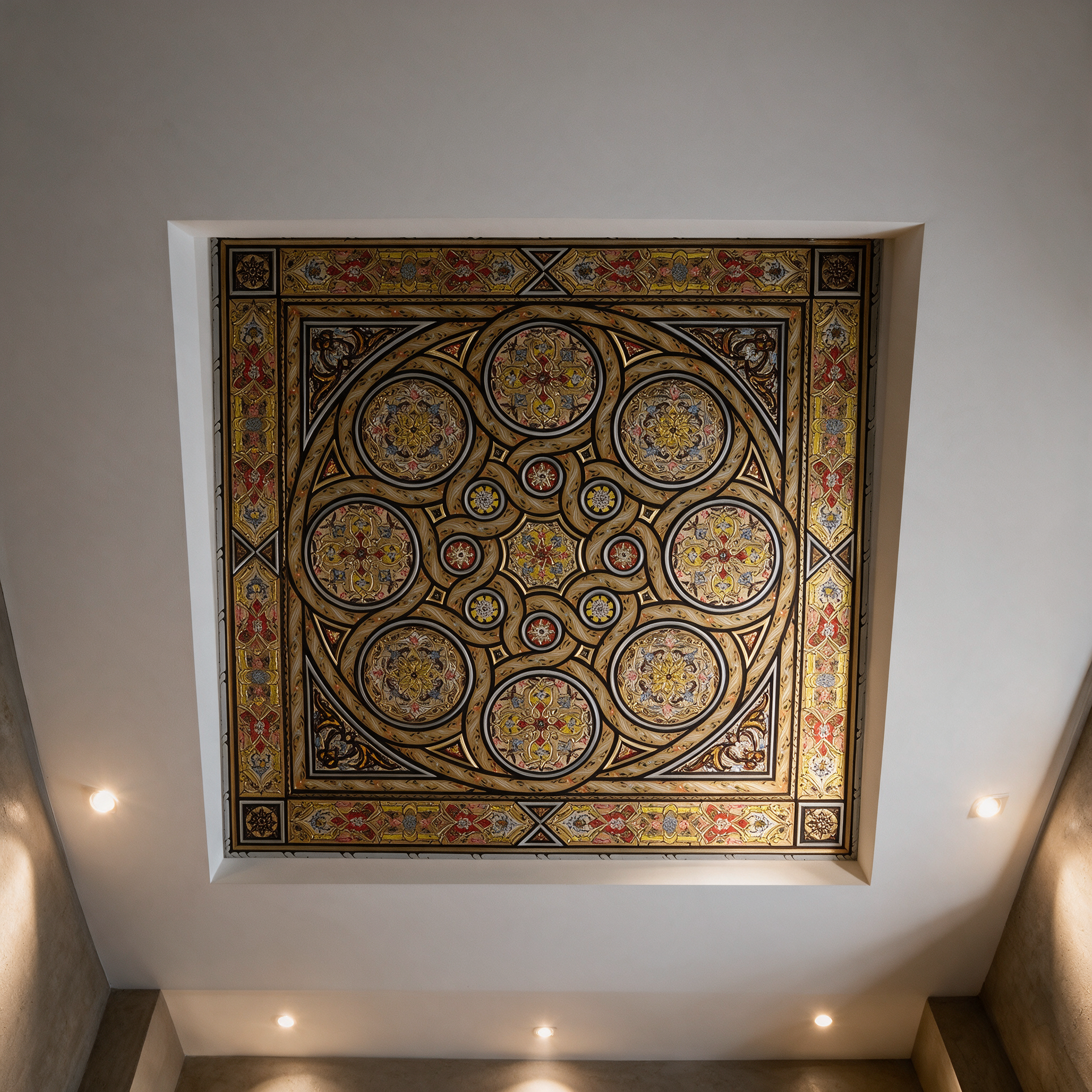 Ceiling of Arabesque Splendor hand-painted Damascene panel installed in the ceiling of a modern Dubai villa